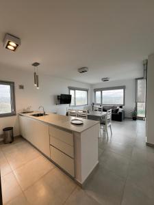 cocina y sala de estar con fregadero y mesa en Torres al mar, en Monte Hermoso