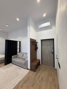 a living room with a couch and a door at Pysanka apartments in Kolomyya