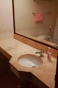 a bathroom counter with a sink and a mirror at City & Mountain View Condotel Near Ayala in Cebu City