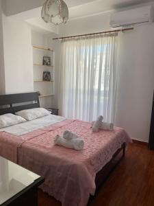 a bedroom with a bed with two towels on it at Northern Comfort Apartment in Athens +13 photos