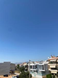 a view of a city with buildings and a blue sky at Northern Comfort Apartment in Athens