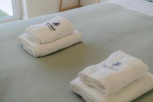 two towels sitting on top of a bed at Best Houses 40 - You me and the sea in Ferrel +20 photos