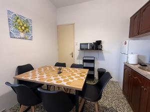 a kitchen with a table and chairs in a room at Marina Helios Home in Áyios Yeóryios +9 photos