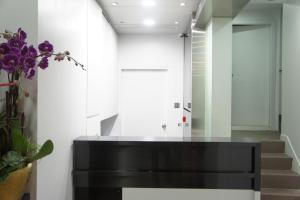 a black console table in a hallway with stairs at Homy Central in Hong Kong