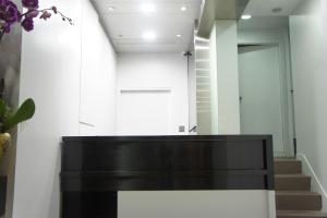 a black piano in a hallway with stairs at Homy Central in Hong Kong