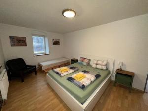 a bedroom with a bed and a desk and a chair at Penzion Bamako in Chřibská