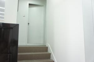 a hallway with stairs and a door in a building at Homy Central in Hong Kong