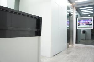 a large flat screen tv on a wall in a building at Homy Central in Hong Kong