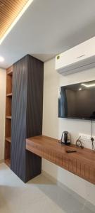 a wooden desk in a room with a tv at RadhaKrishna Executive in Tuljapur