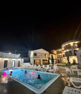 a group of people in a swimming pool at night at Shato Mash in Tbilisi City