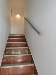 a set of stairs in an empty room at Casasjerezanas Valerian in Jerez de la Frontera +10 photos