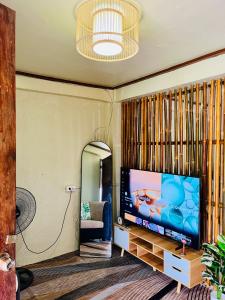 a living room with a flat screen tv on a wall at Casa Huway in El Nido