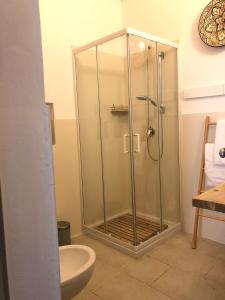a shower stall in a bathroom with a toilet at Alcova'800 in Ostuni +29 photos