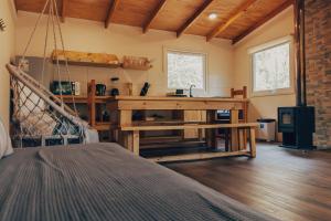 a room with a wooden table in a room at Aldea Molco Cabaña PEWEN in Villarrica