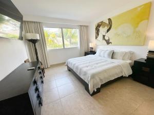 a bedroom with a bed and a painting on the wall at Beach Apartment At Nikki Residences 2 Bedroom in El Chirú +32 photos