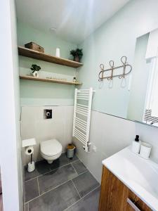 a bathroom with a toilet and a sink at Petite maison sur la colline 