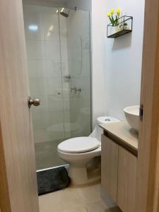 a bathroom with a toilet and a glass shower at Vicmag House Barranquilla in Barranquilla +5 photos