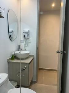 a bathroom with a sink and a mirror at Vicmag house barranquilla in Barranquilla