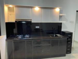 a kitchen with stainless steel cabinets and a sink at Highway View Transit Kiribathgoda in Kiribathgoda +8 photos