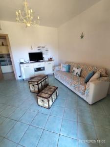 a living room with a couch and a tv at Residenza Le Agavi in Capoliveri in Capoliveri