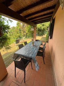 a table and chairs sitting on a patio at Residenza Le Agavi in Capoliveri in Capoliveri