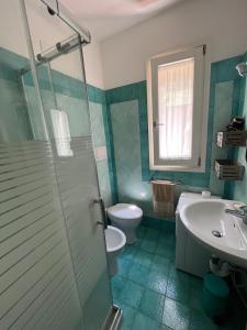 a bathroom with a toilet and a sink and a shower at Residenza Le Agavi in Capoliveri in Capoliveri