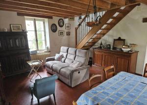 a living room with a couch and a bed at Berrichonne house near Beauval Zoo in Jeu-Maloches