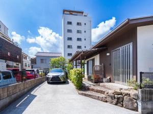 a car parked on a street next to a building at 88kawaramachi 一軒家 in Takamatsu
