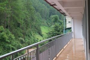 a balcony with a view of a forest at Nhà Bên Suối 