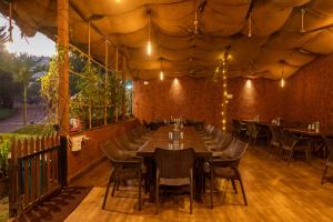a restaurant with tables and chairs in a room at Dandeli Wild River Resort in Dandeli +27 photos