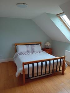 a bedroom with a bed in a attic at Barna Liaga House in Tullamore
