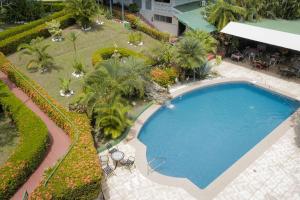 an overhead view of a swimming pool at a resort at Hotel Divisamar by LHR in Manuel Antonio +18 photos