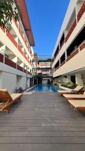 an empty courtyard of an apartment building with a swimming pool at Alzeto Coliving in Legian