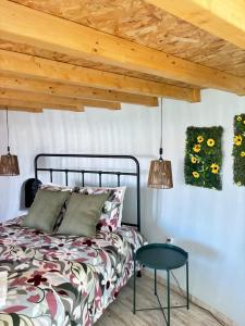 a bedroom with a bed and a table at Casinhas dos Valados in Atouguia da Baleia