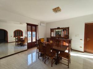 a dining room with a table and chairs and a mirror at La Serenita' in Marco Simone