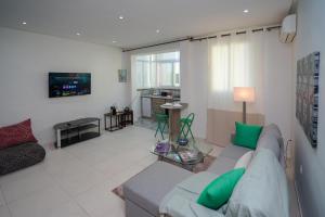 a living room with a couch and a tv at Luxury Fes Studio - ALHAMBRA Suites in Fès