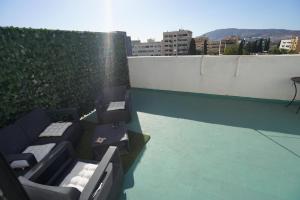 a view of a rooftop with two benches on a building at Luxury Fes Studio - ALHAMBRA Suites in Fès