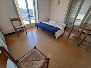 a bedroom with a bed and a table and a chair at SOLARIA Apartment in Brescia