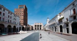 an empty street in a city with buildings at SOLARIA Apartment in Brescia