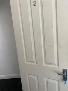 a white door with a handle in a room at Spacious Guest House Thornton Road, London in London +4 photos