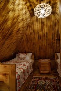 a bedroom with a bed in a wooden house at Ranč Kuzmanović in Doboj