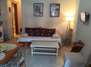 a living room with a couch and a table at Olga's House in Preveza