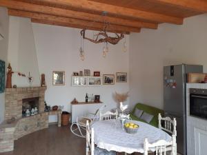a dining room with a table with chairs and a fireplace at Podere MiaMa in Ripalta