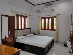 Ένα ή περισσότερα κρεβάτια σε δωμάτιο στο Prasads Homestay
