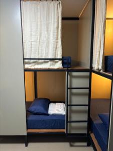 a room with two bunk beds and a window at Mari hostel in Koh Tao