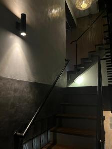 a staircase in a building with a light on the wall at Mari hostel in Koh Tao +9 photos