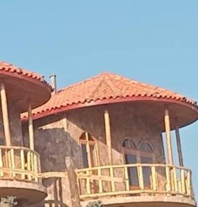a large building with a roof on top of it at Kitabi EcoCenter in Gabegi