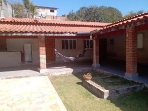 a house with a hammock in front of it at Chácara da Nina - Itatiba in Itatiba