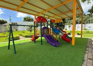 a playground with a slide in a park at Ahuachapan Tiny Rental Homes in Ahuachapán