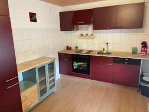 a kitchen with purple cabinets and a counter top at Ferienhaus Söten Wind in Upgant-Schott